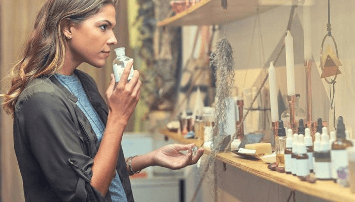 lady smells products to show the impact on Smell strategy impact on consumer
